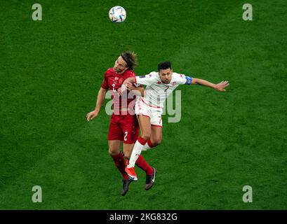 Tunisia's Youssef Msakni (right) and Denmark's Joachim Andersen battle for the ball during the FIFA World Cup Group D match at Education City Stadium, Al Rayyan. Picture date: Tuesday November 22, 2022. Stock Photo