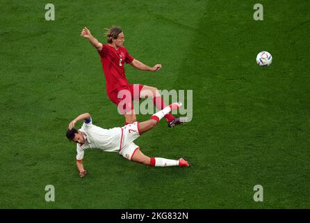 Tunisia's Youssef Msakni and Denmark's Joachim Andersen (right) battle for the ball during the FIFA World Cup Group D match at Education City Stadium, Al Rayyan. Picture date: Tuesday November 22, 2022. Stock Photo
