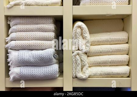 warm blankets are stacked on a shelf in the closet. shop window. Stock Photo