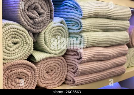 warm blankets are stacked on a shelf in the closet. shop window. Stock Photo