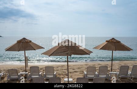 Beach umbrellas on Chahue Beach in the Bahias of Huatulco on the Pacific Coast of Oaxaca, Mexico. Stock Photo