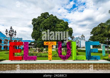 The Pueblo Magico sign of El Tule, in the town of Santa Maria del Tule in the valley of Oaxaca, Mexico.  Behind the sign is the Tree of Tule, with the Stock Photo