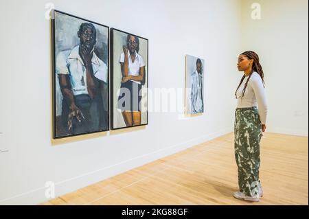 London, UK. 22nd Nov, 2022. Fever of Lilies, 2016, with For the Sake of Angels, 2018 - Fly in League with the Night - A survey exhibition of British artist Lynette Yiadom-Boakye at Tate Britain. Widely considered to be one of the most important painters working today, she is known for her eingmatic and atmospheric paintings depicting human subjects crafted from her own imagination. Credit: Guy Bell/Alamy Live News Stock Photo