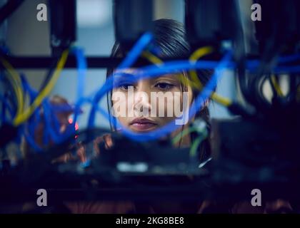 Close-up of female technician working in server room Stock Photo