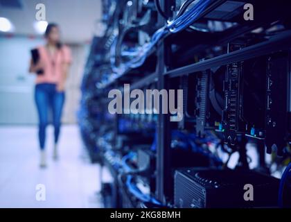 Female technician working in server room Stock Photo
