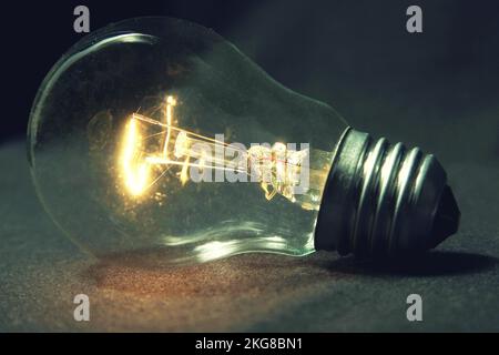 the light bulb glows without wires on the table Stock Photo