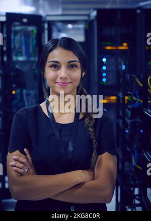 Portrait of smiling female technician in server room Stock Photo