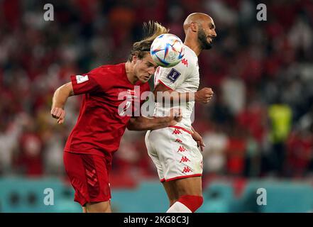 Denmark's Joachim Andersen and Tunisia's Issam Jebali (right) battle for the ball during the FIFA World Cup Group D match at Education City Stadium, Al Rayyan, Qatar. Picture date: Tuesday November 22, 2022. Stock Photo