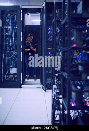 Female technician working in server room Stock Photo