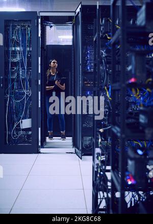 Female technician working in server room Stock Photo