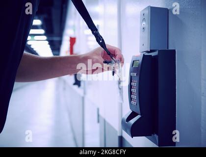 Close-up of employee using keycard and digital door lock in office Stock Photo