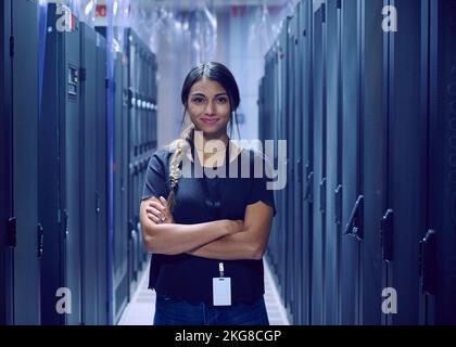Portrait of smiling female technician standing in server room Stock Photo