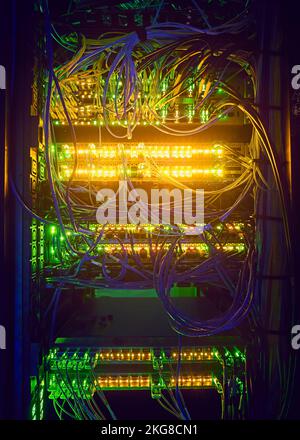 Illuminated network cables in server room Stock Photo