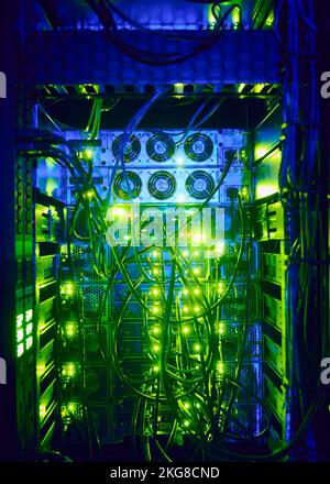 Illuminated network cables in server room Stock Photo