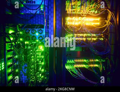 Illuminated network cables in server room Stock Photo