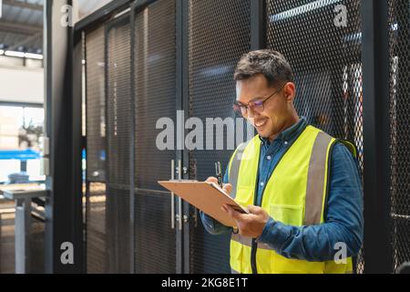 Happy asian male engineer worker enjoy working in factory industry Stock Photo