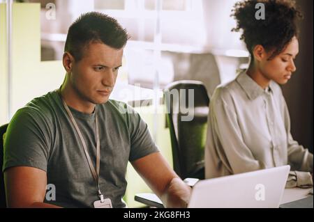 Two office workers focused on their work Stock Photo