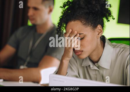 Modern office employee suffering from work-related stress Stock Photo