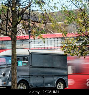 Epsom, Surrey, London UK, November 20 2022, Surrealistic Image Of A Public Transport Bus Passing Traffic Lights On A Main Road With blurred Motion Ind Stock Photo
