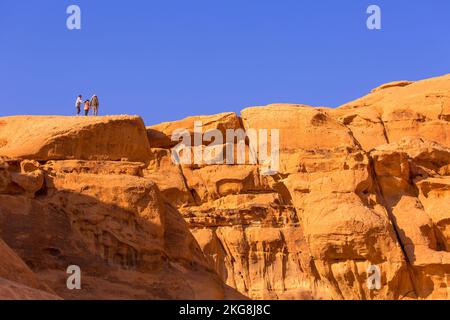 Jordan, Wadi Rum - November 2, 2022: Famous Um Frouth natural stone bridge arch and tourists in the desert landmark Stock Photo