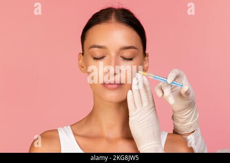 Beautician Doctor Making Injection To Beautiful Woman With Drawn Mesh On Face Stock Photo