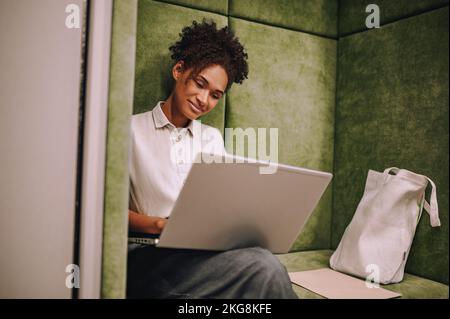 Concentrated young woman working on her portable computer Stock Photo