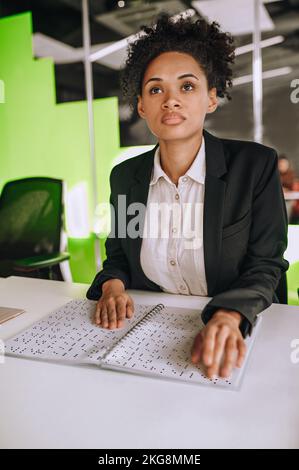 Visually impaired person using Braille at work Stock Photo