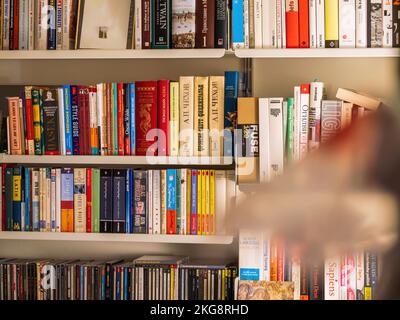 London, United Kingdom - Jan 1, 2022: Multiple books on the modern luxury furniture - 606 Universal Shelving System by Vitsoe Stock Photo