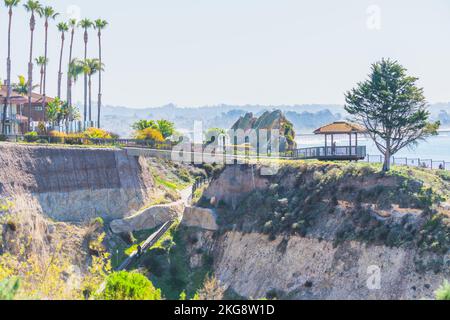 Pismo Beach, California, USA - March 1, 2021  Pismo Beach cliffs, beach hotel, and gazebo with tourists overlooking the ocean Stock Photo