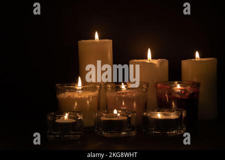 photo of lighted candles in three rows Stock Photo
