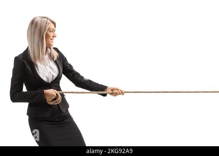 Profile shot of a young businesswoman pulling a rope isolated on white background Stock Photo