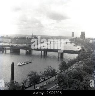 1950s, historical, view from above, possibly from the Shell Mex House, on the North side of the River Thames overlooking the Victoria Embankment, the River and the surrounding area of London. The Palace of Westminster, home of the UK Government and the Clock Tower (Big Ben) are on the right of the picture. On the near left, Cleopatra's Needle, a obelisk transported from Egypt to London in 1877. Stock Photo