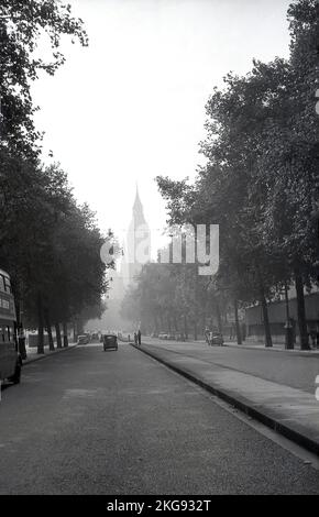 1950s, historical view from this era of Victoria Embankment, Westminster, London, England, UK, a road and river-walk on the North side of the River Thames. The Clock Tower and the Palace of Westminster is seen in the distance. Part of the Thames Embankment, it was opened in 1870. Stock Photo