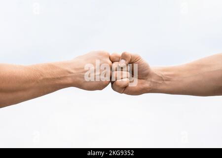 Teamwork and friendship. Partnership concept. Man giving fist bump. Bumping fists together. Fist Bump. Clash of two fists. Concept of confrontation Stock Photo