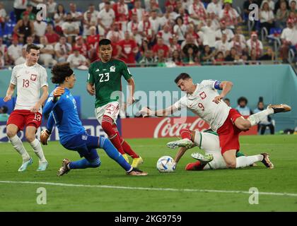 Doha, Qatar. 22nd Nov, 2022. Soccer: World Cup, Mexico - Poland, Preliminary round, Group C, Matchday 1, Stadium 974, Robert Lewandowski (r) of Poland is fouled by Hector Moreno (covered) of Mexico in the penalty area. Lewandowski is unable to convert the ensuing penalty kick. On the left are Jakub Kaminski of Poland and goalkeeper Guillermo Ochoa and Jesus Gallardo of Mexico. Credit: Christian Charisius/dpa/Alamy Live News Stock Photo