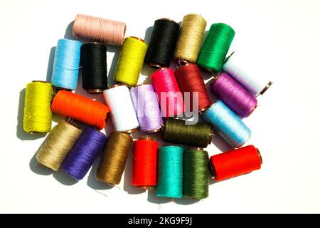 Multi-color silk thread coils on white background. Stock Photo