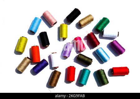 Multi-color silk thread coils on white background. Stock Photo