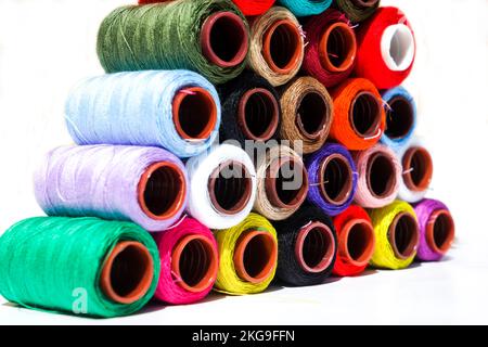 Multi-color silk thread coils on white background. Stock Photo