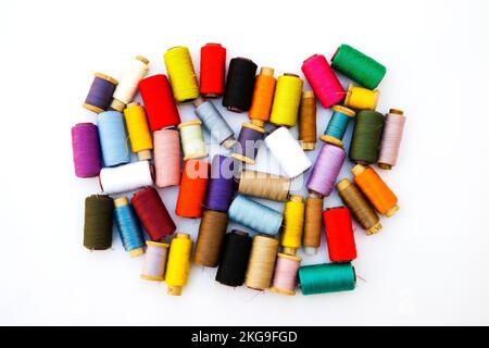 Multi-color silk thread coils on white background. Stock Photo