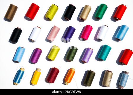 Multi-color silk thread coils on white background. Stock Photo