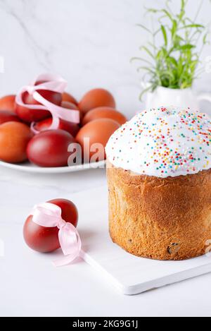 Traditional easter cake or sweet bread and eggs in white table. Copy space.  Stock Photo