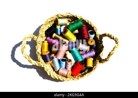 Wicker basket with balls of knitting yarn on white background, close up Stock Photo