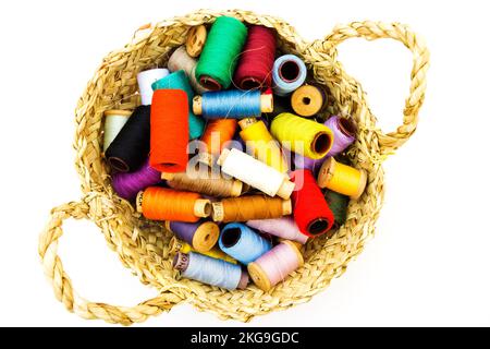 Wicker basket with balls of knitting yarn on white background, close up Stock Photo