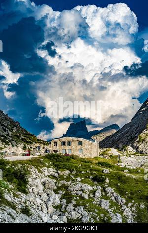 Description: Huge thunderclouds pile up over the Falzarago World War Museum in the evening. Falzarego pass, Dolomites, South Tirol, Italy, Europe. Stock Photo