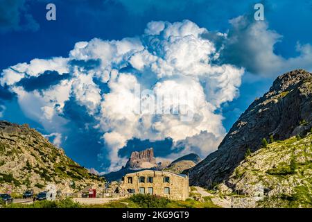 Description: Huge thunderclouds pile up over the Falzarago World War Museum in the evening. Falzarego pass, Dolomites, South Tirol, Italy, Europe. Stock Photo