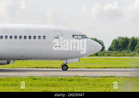 Passenger airplane portholes nose cockpit, side view. Stock Photo