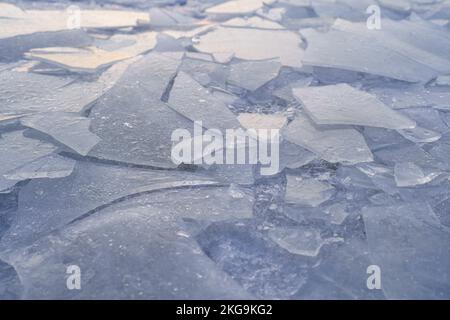 Ice background. Frozen river or lake with cracks in winter Stock Photo