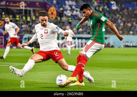 DOHA, QATAR - NOVEMBER 22: Matty Cash of Poland battles for the ball with Jesus Gallardo of Mexico during the Group C - FIFA World Cup Qatar 2022 match between Mexico and Poland at Stadium 974 on November 22, 2022 in Doha, Qatar (Photo by Pablo Morano/BSR Agency) Stock Photo