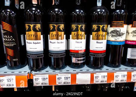 Turkish red wine bottles on a supermarket shelf. Wine from Turkey with price tags. Terra Okuzgozu Kirmizi wine from Turkey, bottle. Stock Photo