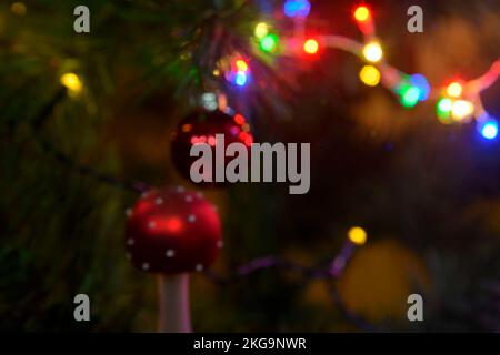 Lights on Christmas tree. Christmas and New Year decorations on Christmas tree. Closeup of Christmas tree decorations. Defocused Stock Photo